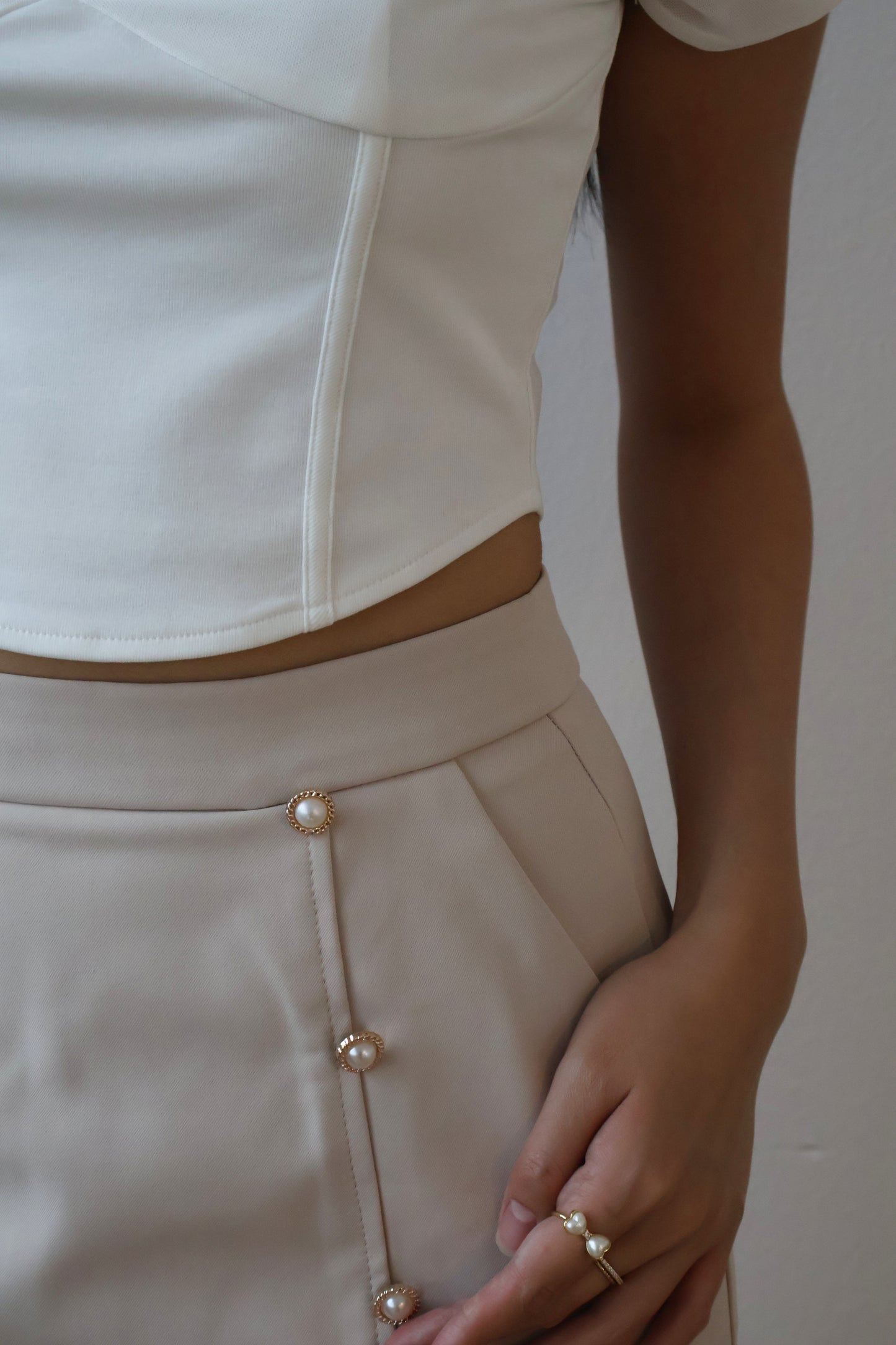 Rayne Pearl Button Pleated Skirt In Taupe