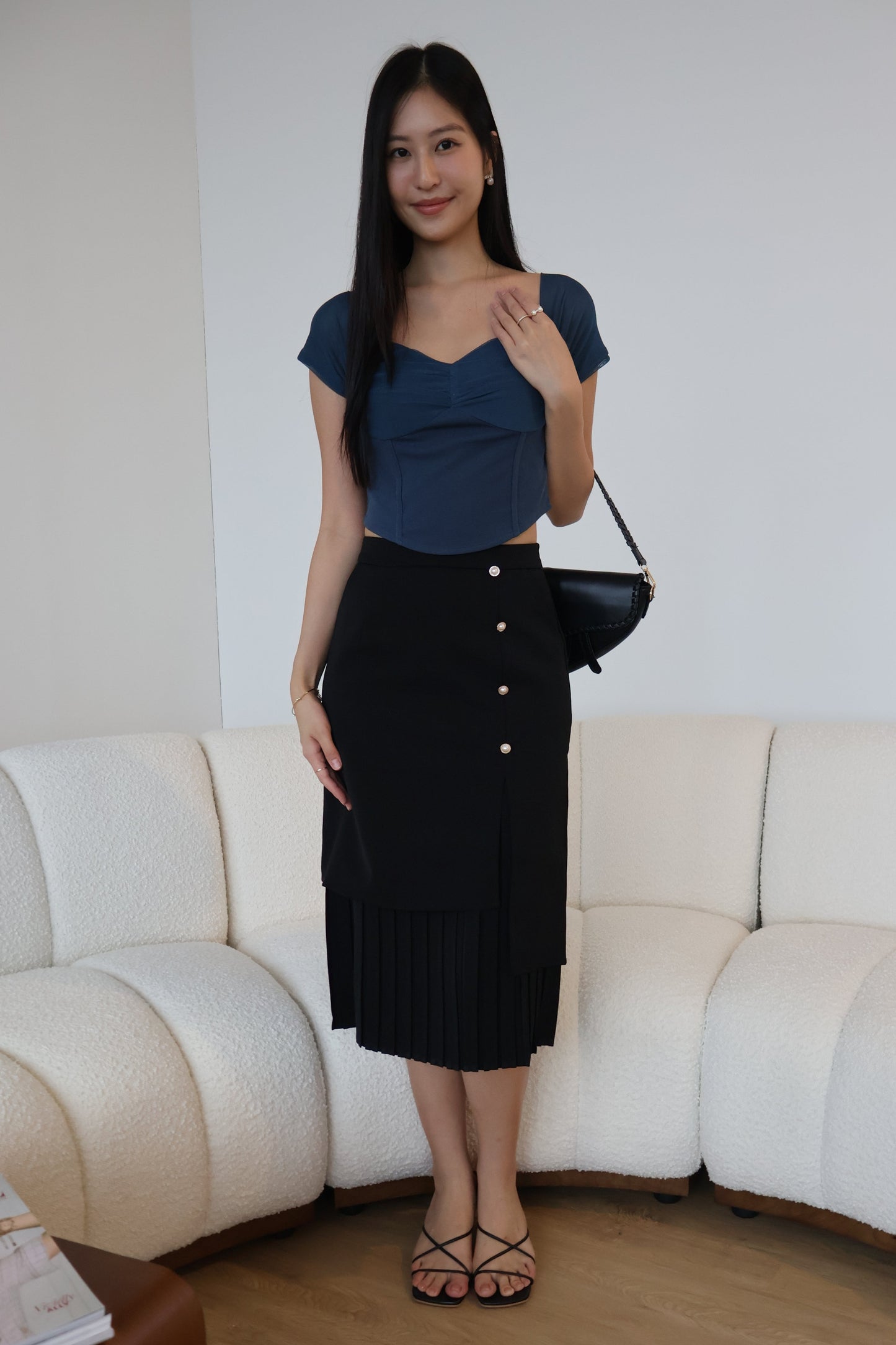 Rayne Pearl Button Pleated Skirt In Black