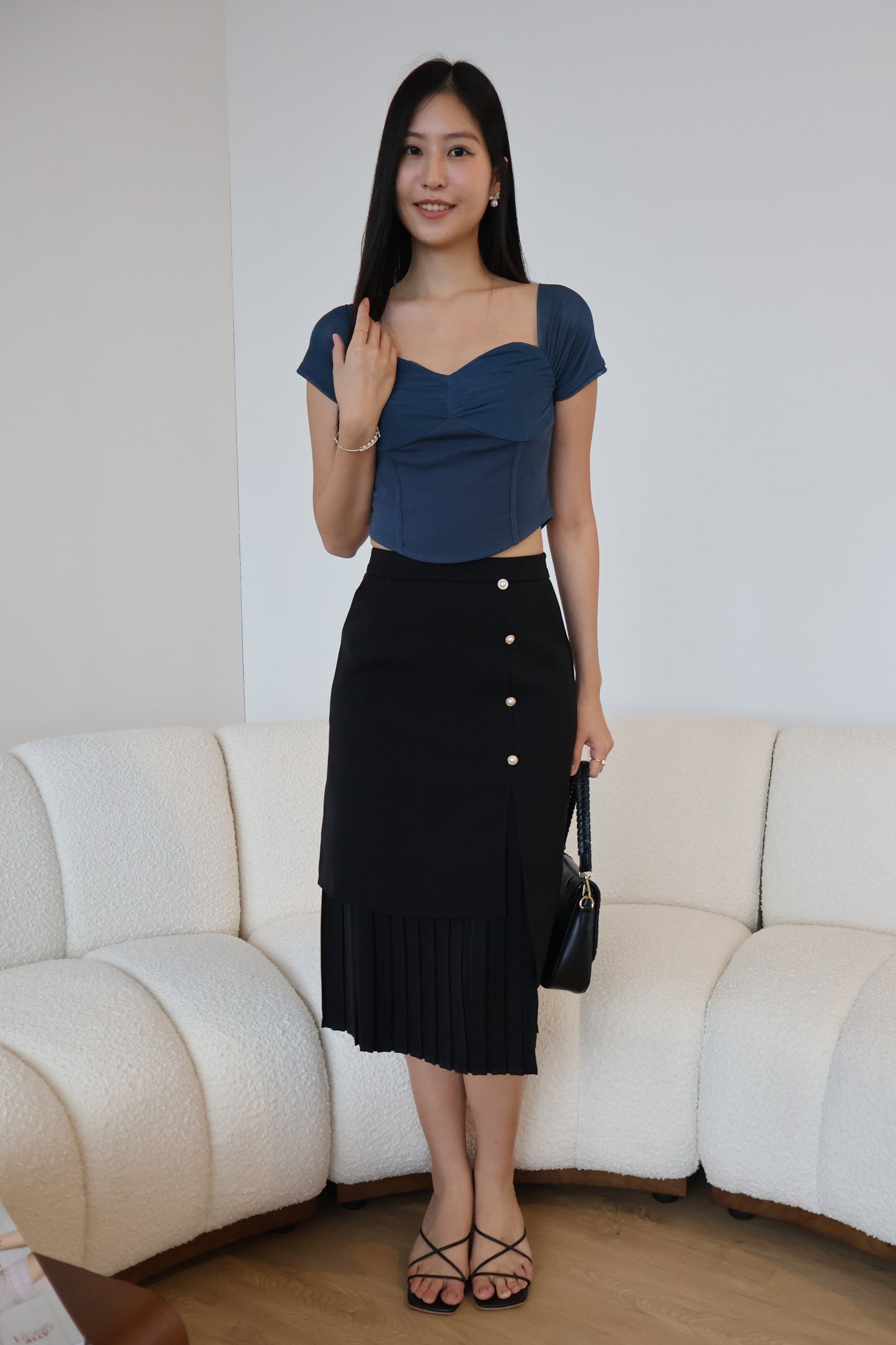 Rayne Pearl Button Pleated Skirt In Black